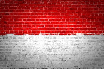 Fototapeta na wymiar Shot of the Indonesia flag painted on a brick wall in an urban location