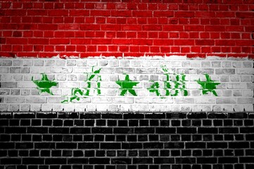 The Iraq flag painted on a brick wall in an urban location