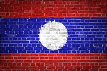 The Laos flag painted on a brick wall in an urban location