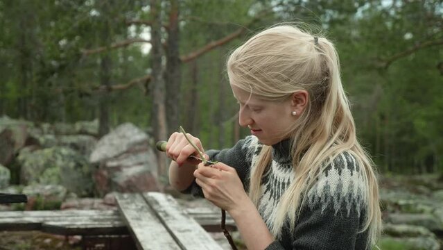 Blond Nordic Woman Woodcarving Outdoors, Medium Shot