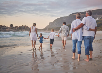 Family, generations and back with walking, beach and sunset with men, women and children with love....