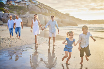 Family, generations and kids with running, beach and sunset with men, women and happiness with...