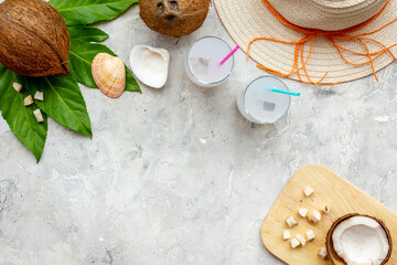 Fresh coconut milk cocktail in glasses with straw beach hat