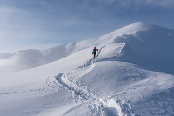 Mountaineer climbing in the snow at tatras Ridge, Poland ans Slovakia