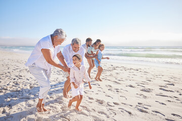 Vacation, travel and big family running on the beach for playing, bonding and spending quality time. Happy, excited and children having fun with their grandparents and parents by the ocean on holiday