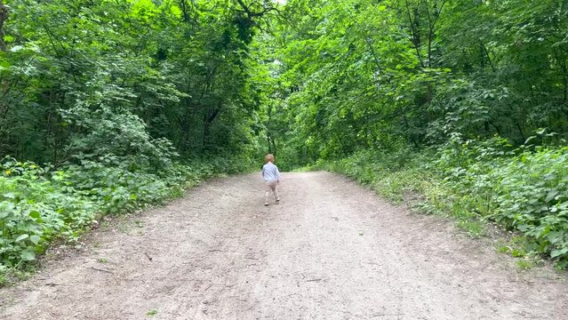 A little girl is running on a path in the park