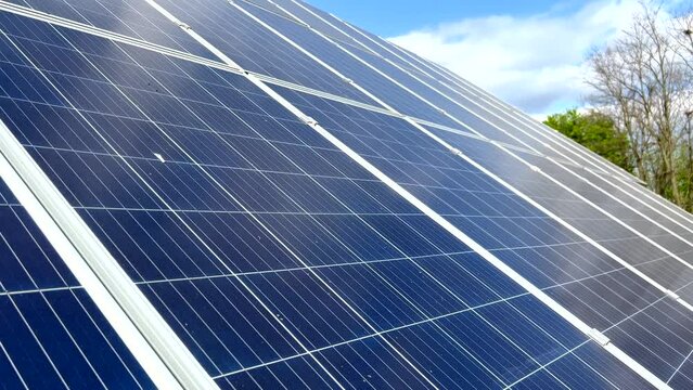 Closeup of surface of blue photovoltaic solar panels mounted on building roof for producing clean ecological electricity. Production of renewable energy concept