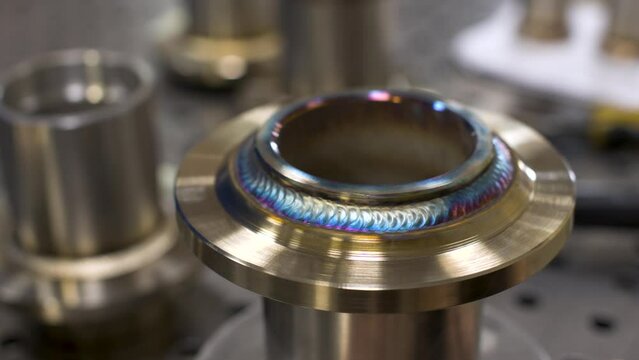 Demonstration of a weld in the manufacture of stainless steel flanges. factory industrial production. Close-up