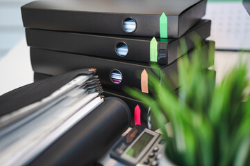 Table full of documents. Office folders, binders.