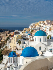Fototapeta premium Iconic views of blue domes and white buildings in Santorini, Greece