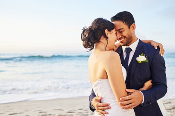 Wedding day, hug and couple at a beach for love, union and celebration against a nature background....
