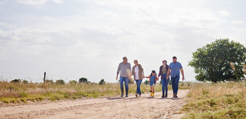 Love, happy family walking holding hands and on a farm with blue sky. Support or care, happiness or...