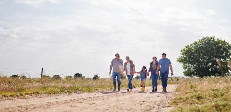 Love, happy family walking holding hands and on a farm with blue sky. Support or care, happiness or agriculture and people walk outdoors by countryside or rural environment together with generation