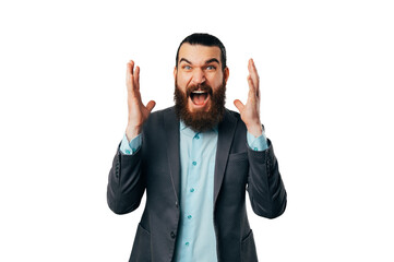 Fototapeta premium Excited bearded man is screaming out loud that he has got some good news.