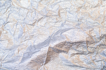 Background of silver and golden wrinkled crepe tissue paper