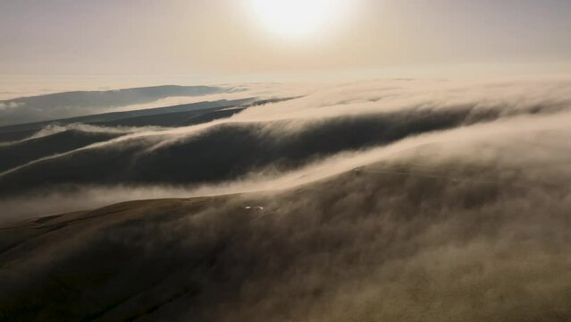 4k timelapse of flowing masses of fog over the hills in the early morning or at sunset. Air view. weather change