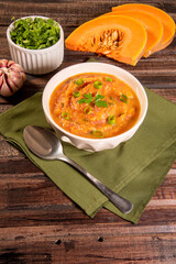 Homemade pumpkin cream, accompanied by spices. pumpkin broth