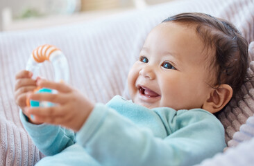 Happy baby, rattle and child in bedroom for childhood development, growth and cute smile at home....
