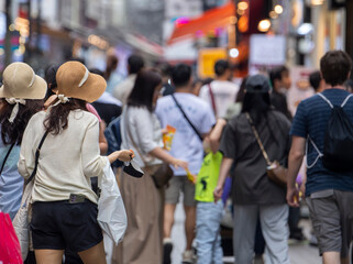 Crowd of people walking in Seoul. People walking on busy street of Myeongdong.