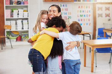 Care, teacher with school children hug and in a classroom with a lens flare. Support or love, happiness or teaching and happy or cheerful woman with kindergarten kids hugging together in a class