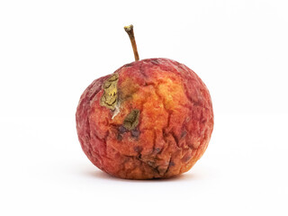 Spoiled apple with wrinkles on a white isolated background