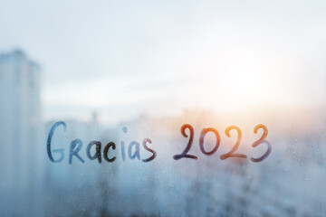 lettering thanks Gracias in Spanish is thanks in english and numbers 2023 paint with finger with...