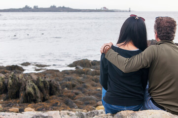 Couple looking out over casco bay in Maine