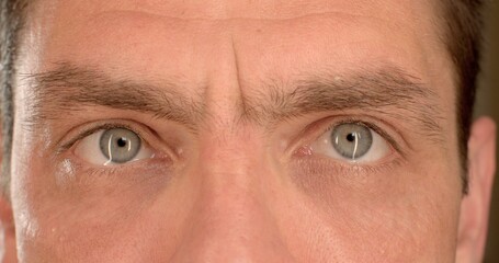 Frequent blinking mental excitement. Close-up of the face. The joyful eyes of the man blink. Wet...