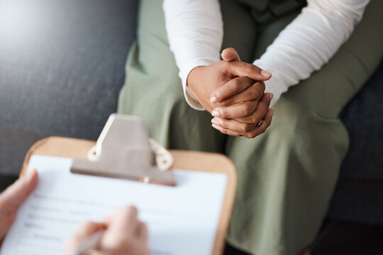 Woman, hands and therapist writing on clipboard in consultation for mental health, psychology or healthcare. Hand of female person or psychologist consulting patient with anxiety or stress in therapy