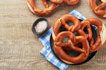 Oktoberfest concept card. Traditional Bavarian pretzels with beer bottle mug on old rustic wooden background. Perfect for Octoberfest. Oktoberfest food menu. Top view. Mock up.