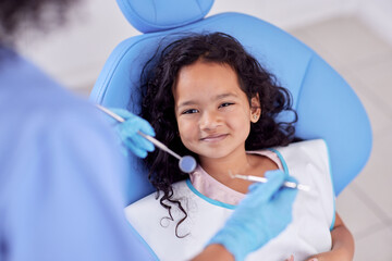 Dentistry, portrait and girl child at the dentist for teeth cleaning, oral checkup or consultation. Healthcare, smile and kid laying on the chair for dental mouth examination with equipment in clinic