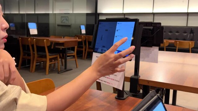 a person who orders food from a table tablet in a restaurant
