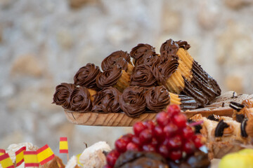 Churros filled with chocolate. Typical Spanish artisanal pastry. Appetizing sweet dish, tasty dessert. Ready to go snack. Take away meal. Street pastries, medieval market. Traditional urban food Spain