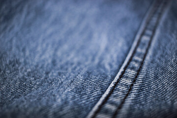 The texture of the blue jeans with the detail of the fabric.