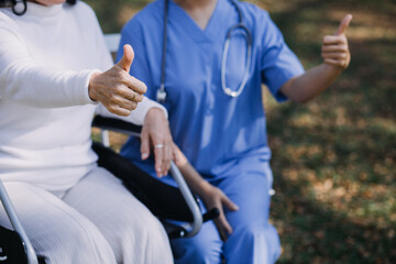 young asian physical therapist working with senior woman on walking with a walker