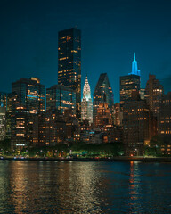 Fototapeta na wymiar View of the Chrysler Building and Midtown Manhattan skyline at night from Roosevelt Island, New York