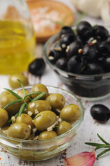 Black and green olives in glass bowls