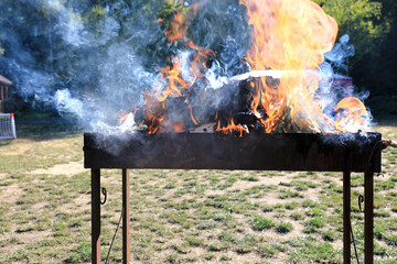 Burning firewood in grill