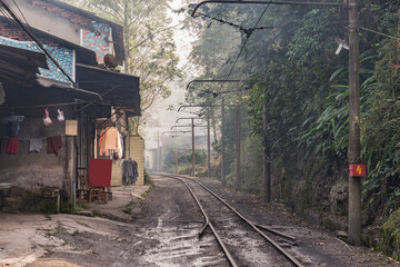 Narrow railway line along the village. China.