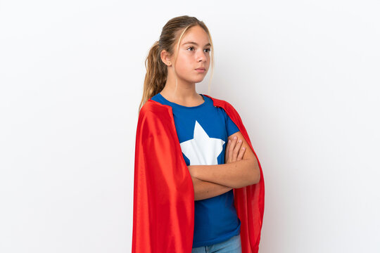 Little caucasian girl isolated on white background in superhero costume with arms crossed