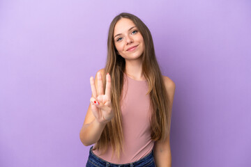 Young Lithuanian woman isolated on purple background happy and counting three with fingers