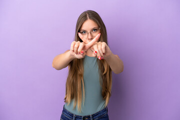 Young Lithuanian woman isolated on purple background making stop gesture with her hand to stop an act