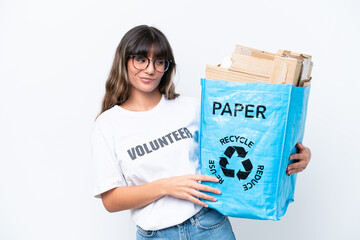 Young caucasian woman holding a recycling bag full of paper to recycle isolated on white background with sad expression