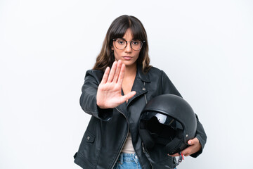 Obraz premium Young caucasian woman with a motorcycle helmet isolated on white background making stop gesture