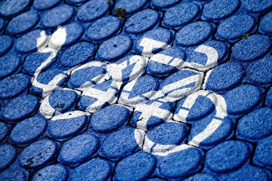 Electric bicycle charging road marking. Horizontal image with selective focus.