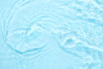 Fototapeta na wymiar Water blue surface abstract background. Waves and ripples of cosmetic moisturizer with bubbles