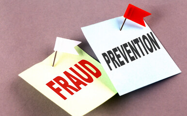 FRAUD PREVENTION text on a sticky on grey background