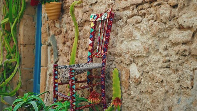A rustic wall in Sicily coast with chair typical decoration