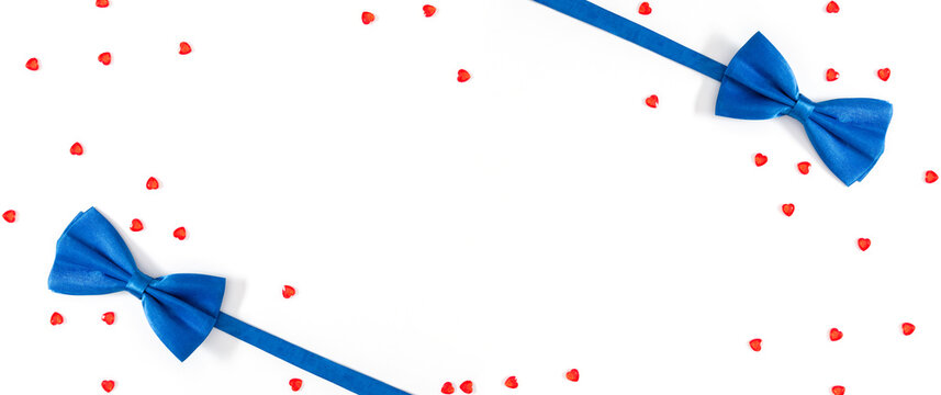 Father's Day concept. Flat lay top view of blue bow ties red heart confetti isolated on white background with space for text or promotion and greeting message, banner
