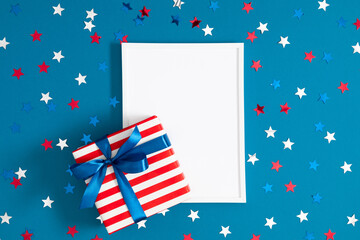4th of July, USA Presidents Day, Independence Day. Blank photo frame striped gift box with bow on...